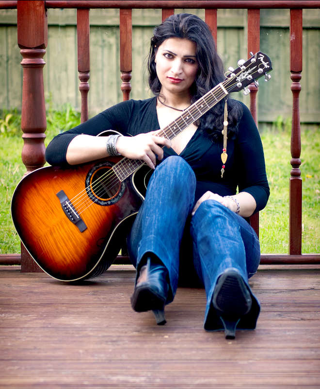 Maddi playing on guitar in garden